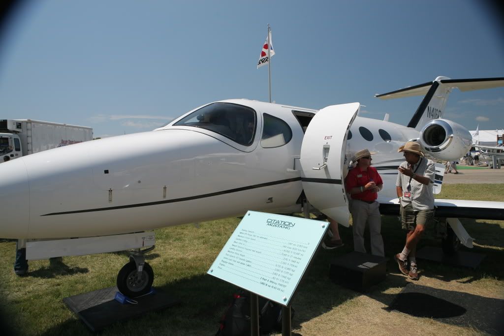 Cessna Mustang parked next to a statistics board